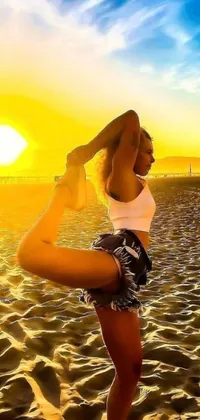 This stunning phone live wallpaper features a woman performing a yoga pose on the beach, basking in the golden sunlight