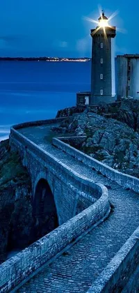 Get mesmerized by this stunning phone live wallpaper featuring a lighthouse standing tall on top of a cliff facing the ocean