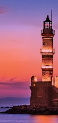 This stunning live wallpaper features a romantic old town Mardin lighthouse in the middle of a beautiful body of water, illuminated by a colorful sunset