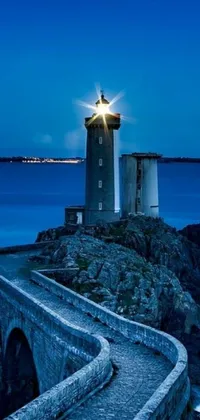 This mesmerizing phone live wallpaper showcases a serene lighthouse on top of a rocky cliff, overlooking the vast ocean