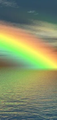 This is a stunning live wallpaper featuring a rainbow over a body of water