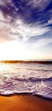 This stunning phone live wallpaper features a serene scene of a surfer gliding on a surfboard atop a sandy beach