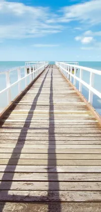 This live wallpaper depicts a long pier stretching into the ocean, captured using tilt shift photography