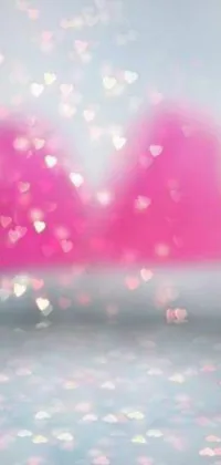 Get mesmerized by the stunning phone live wallpaper featuring pink hearts floating in the air