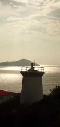Get lost in the beauty of nature with this stunning phone live wallpaper of a Lighthouse overlooking the deep blue ocean