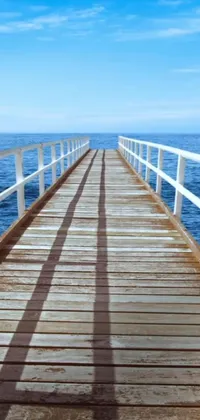 Indulge in serene and beauteous live wallpaper featuring an idyllic wooden pier extending out into the deep blue ocean