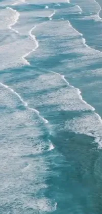 Enjoy the thrill of surfing with this live wallpaper featuring a surfer riding a wave on a beach in Cornwall