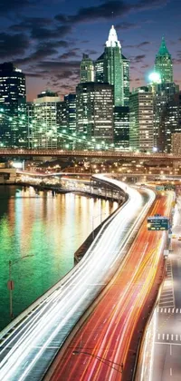 This phone live wallpaper features a stunning long exposure photo of a futuristic city at night, with mesmerizing blue and purple hues illuminating the freeway lights