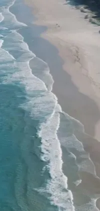 This stunning phone live wallpaper showcases a beautiful ocean landscape with crystal-clear emerald water and soft sand beach