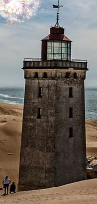 This stunning live wallpaper features a serene scene of a traditional lighthouse on a sandy beach
