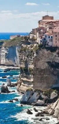 This stunning live wallpaper features a group of Mediterranean-style buildings sitting atop a cliff overlooking the ocean