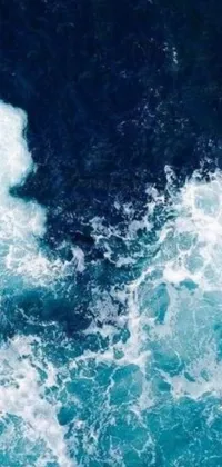 This serene live phone wallpaper showcases a surfer riding a wave surrounded by ocean sprites