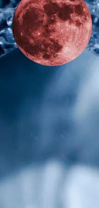 Experience the surreal beauty of a red full moon rising over a peaceful body of water with this unique phone live wallpaper