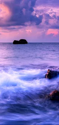 This romantic phone live wallpaper features rocks on a tranquil body of water, with beautiful waves gently moving in the sea