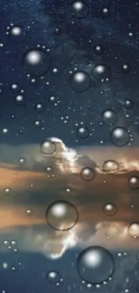 This live wallpaper features a stunning digital art scene of a night sky filled with bubbles hovering over a body of water