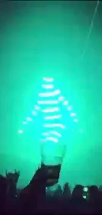 This dynamic phone live wallpaper features a vibrant rave outfit against a green light, creating a mystical effect