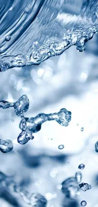 This live wallpaper showcases the mesmerizing flow of water from a faucet, captured in stunning high definition by Shutterstock