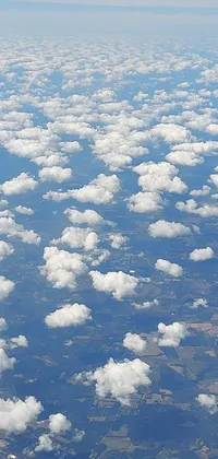 This phone live wallpaper showcases a view of the sky and clouds from an airplane flying over West Virginia