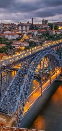 This phone live wallpaper is a stunning depiction of a bridge spanning over a peaceful river with a bustling cityscape in the background
