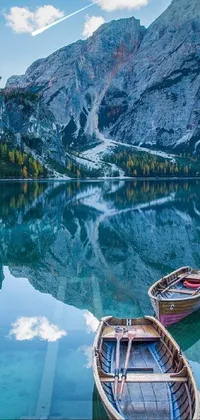 This stunning phone live wallpaper depicts two boats resting on top of a crystal clear lake amidst the breathtaking scenery of Italy's mountainous landscape