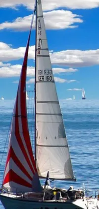This live wallpaper features photorealistic sailboats floating on water