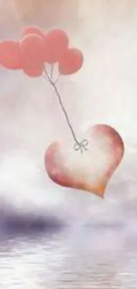 Make your phone screen come alive with this mesmerizing live wallpaper! Featuring a heart-shaped balloon hovering over a tranquil body of water, this beautiful illustration showcases romanticism in its full glory