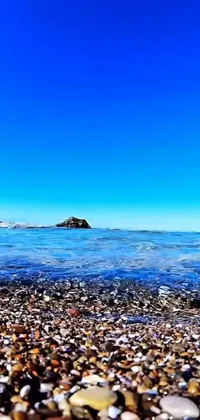 Looking for a stunning live wallpaper to bring a touch of nature to your phone? Check out this beautiful blue beach scene featuring rocks and water