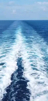 This live wallpaper for your phone shows a stunning view of the ocean from the back of a boat