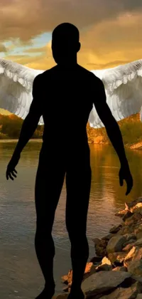 This phone live wallpaper captures a stunning digital art piece of a man with magnificent wings standing next to a serene body of water