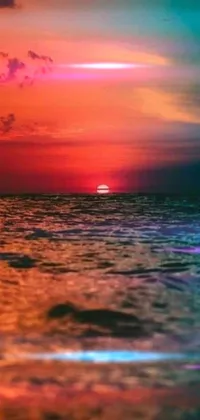 This is a stunning live wallpaper for your phone that features a breathtaking sunset over a tropical beach
