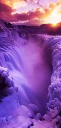 This phone live wallpaper features a stunning frozen waterfall with a gorgeous sunset as the background