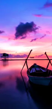 Welcome to our newest phone live wallpaper, featuring a serene boat floating atop calm waters, set against the backdrop of a colorful sunset sky
