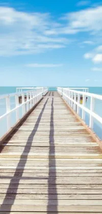 Enjoy the ethereal beauty of this phone live wallpaper displaying a never-ending wooden pier extending into the ocean on a bright summer day