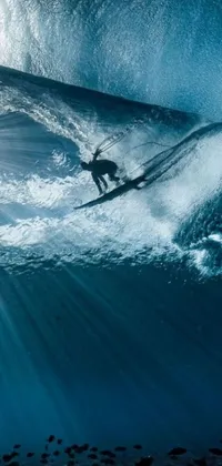 This live wallpaper for your phone displays an image of a skilled surfer riding on top of a wave with a surfboard