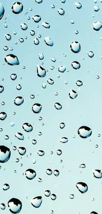 This phone live wallpaper displays a cluster of water droplets on a window, portraying a serene underwater look