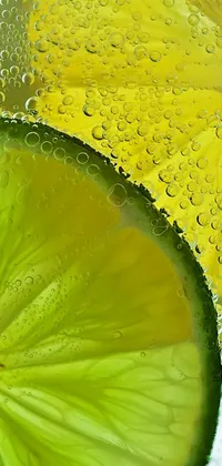 This stunning live wallpaper showcases a true-to-life image of a zesty slice of lime floating in a glass of clear water