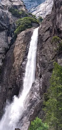 Transform your phone into a serene haven with this live wallpaper featuring a majestic waterfall flowing down a mountainside
