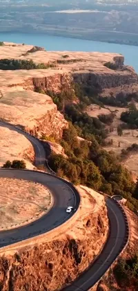 The phone live wallpaper depicts a scenic drive down a winding road in Oregon's natural landscape