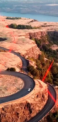 Experience the heart-racing thrill of a car driving down a winding mountain road with this live wallpaper