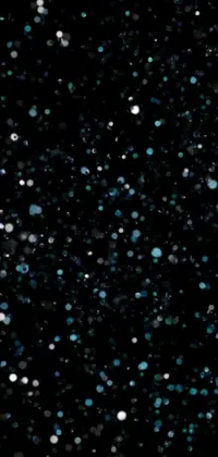 This phone live wallpaper brings a stunning close-up portrait of snowflakes against a captivating background of galaxy-colored blue-black