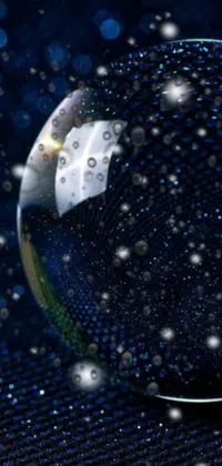 Elevate your phone's home screen with this stunning live wallpaper featuring a glass ball against a starry space backdrop