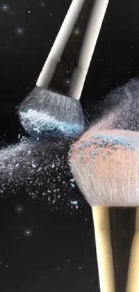 This phone live wallpaper showcases a brush that appears to be dispensing ivory make-up powder