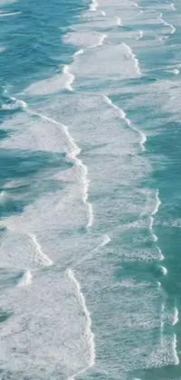 This live phone wallpaper displays an aerial view of a stunning beach and water scene