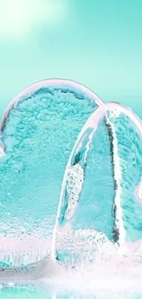 This live wallpaper features two ice hearts in turquoise water on top of a table, with bubbly bath suds surrounding them