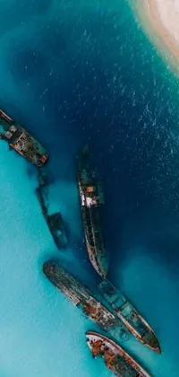 Enjoy the tranquil sight of boats floating on crystal clear waters set against a tilt shift background in this live wallpaper