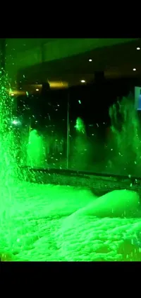 This lively phone live wallpaper features a green fire hydrant shooting water into the air in a dynamic movement
