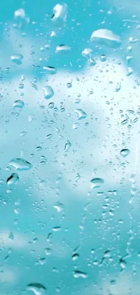 Introducing a visually appealing phone live wallpaper featuring raindrops on a window and a serene light blue water backdrop