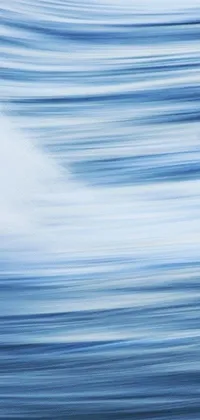 This live phone wallpaper features a serene, dreamy photo of an ocean wave