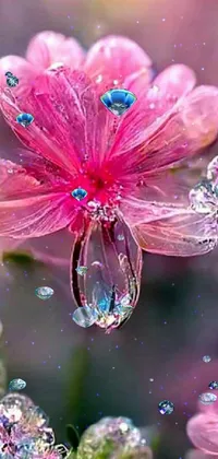 This phone live wallpaper showcases a stunning pink flower with a dewdrop and magical crystals for backdrop