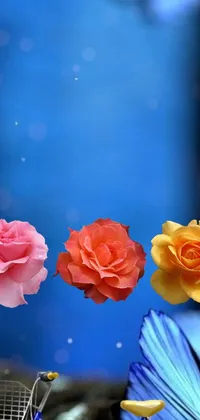 This stunning live phone wallpaper depicts a vibrant bouquet of flowers next to a shopping cart, set against a blue background